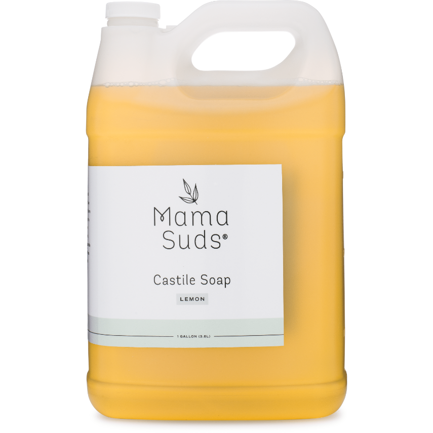 A one-gallon plastic jug of MamaSuds Castile Liquid Soap with a white label, top handle, and yellow-orange soap inside. Made with pure essential oils, this versatile cleaner is ideal for everyday use.