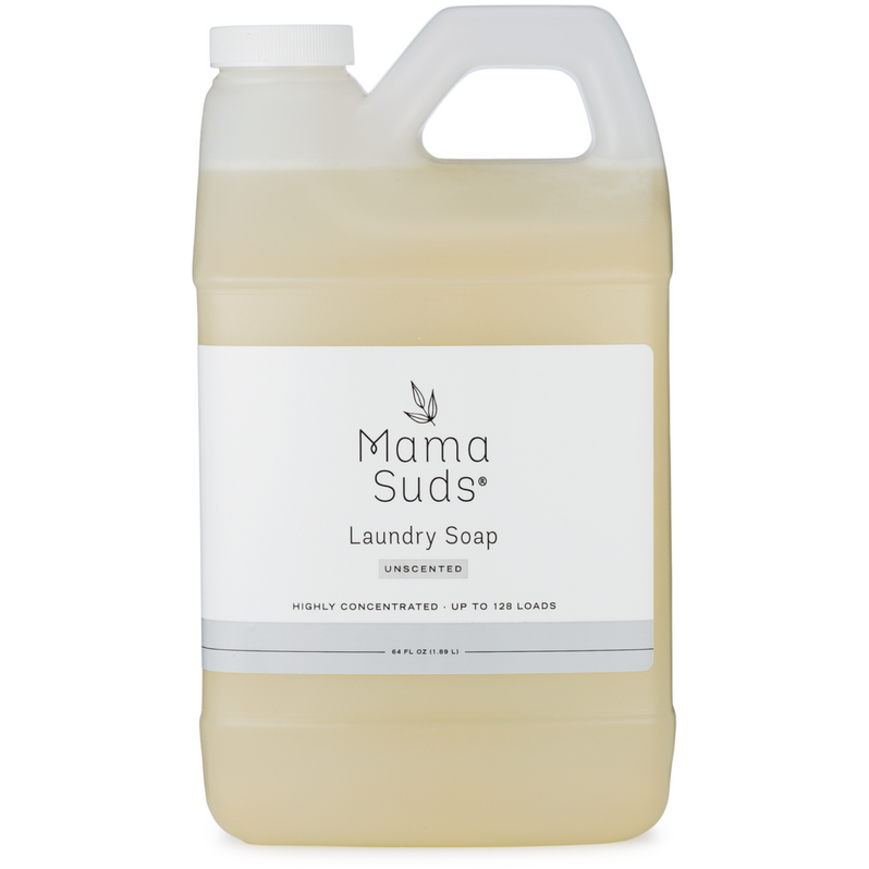 A clear plastic jug with a handle contains light yellow MamaSuds Laundry Detergent Soap, Unscented and Highly Concentrated for up to 128 loads. The eco-friendly, nontoxic product features a white label with black and gray text.