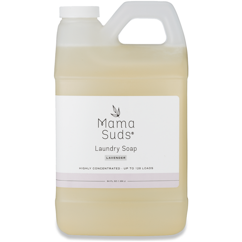 A plastic jug of MamaSuds Laundry Detergent Soap with a white label, black text, and leaf logo. This eco-friendly container holds light yellow, nontoxic detergent and features a handle with a screw cap.