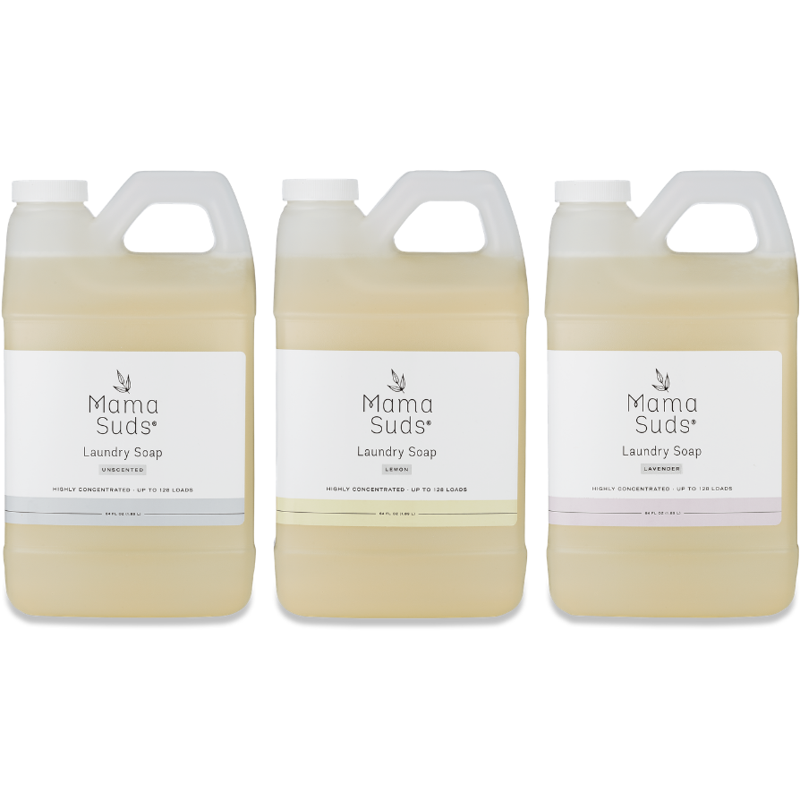 Three large jugs of MamaSuds Laundry Detergent Soap, each in a semi-transparent handled container with a white label featuring different colored accent lines for various scents, are arranged side by side. This detergent is eco-friendly and nontoxic.