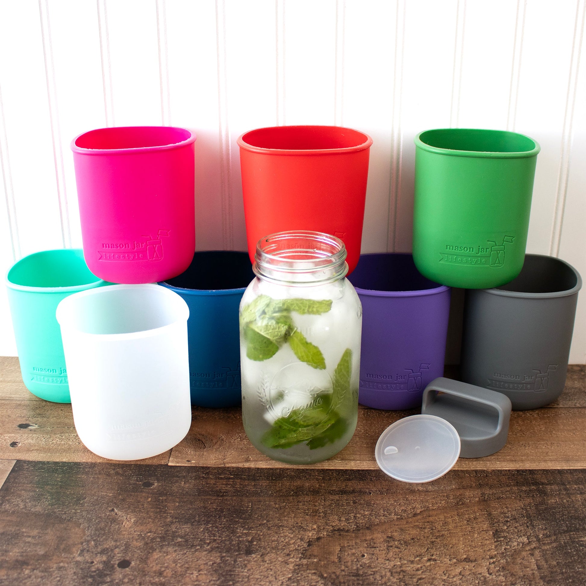 Colorful Mason Jar Lifestyle 32oz glass water bottle with silicone sleeve and carry handle in various vibrant shades.