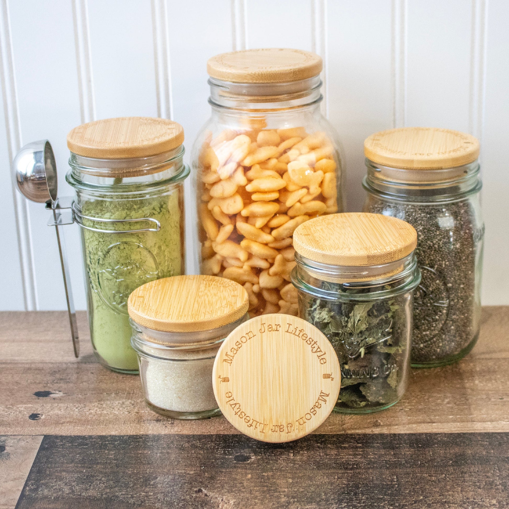 Bamboo storage stopper lids for Mason jars, ideal for snacks, pantry, and meal prep, by Mason Jar Lifestyle.