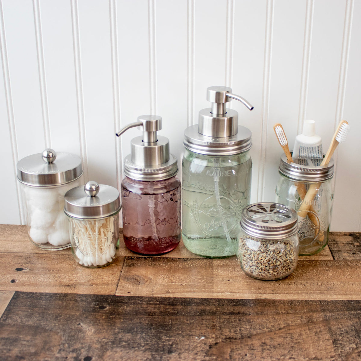 Stainless steel foaming soap pump dispenser on a mason jar, ideal for kitchen or bathroom use, with a wide-mouth jar and apothecary style.