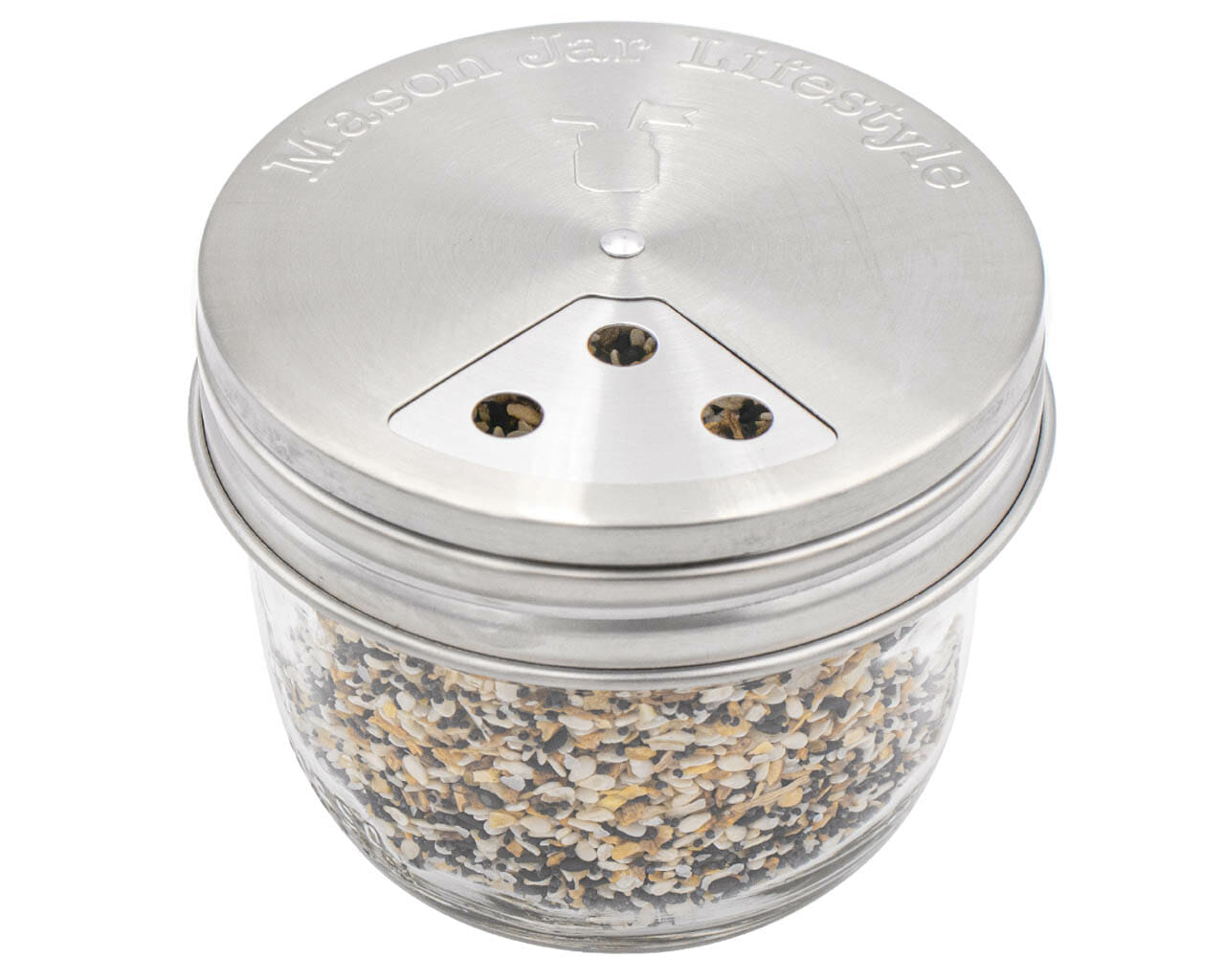The Mason Jar Lifestyle Spice Shaker Stainless Steel Lids for Mason Jars (4 Pack) feature a triangular metal shaker plate with three holes, fit glass mason jars, and are dishwasher safe for easy cleaning.