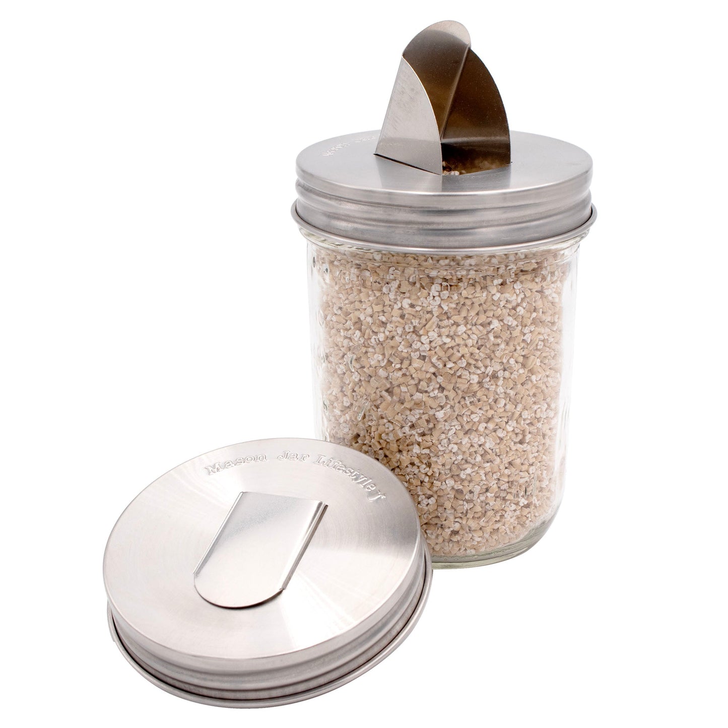 Two stainless steel lids with grain dispensers for regular-mouth mason jars, designed by Mason Jar Lifestyle.