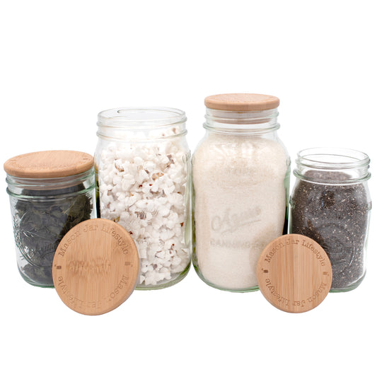 Set of Mason Jar Lifestyle bamboo storage stopper lids for regular-mouth mason jars, featuring natural wood finish and logo details.