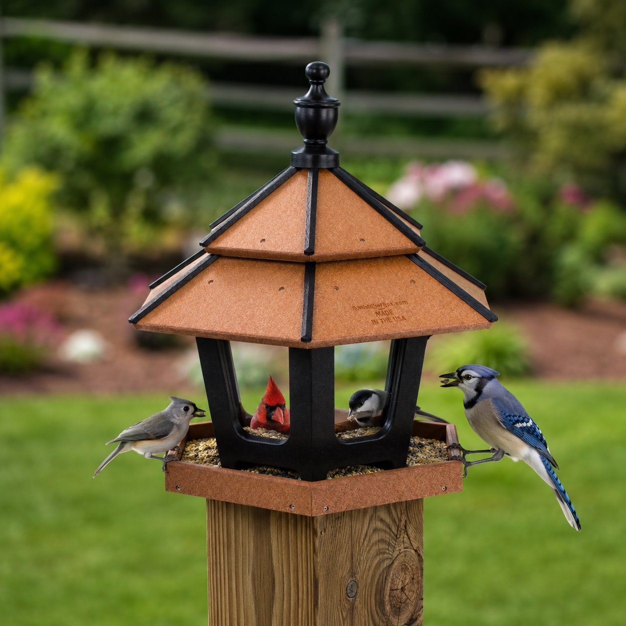 AmishToyBox.com triple compartment gazebo bird feeder mounted on a post, featuring multiple feeding sections for garden birds.