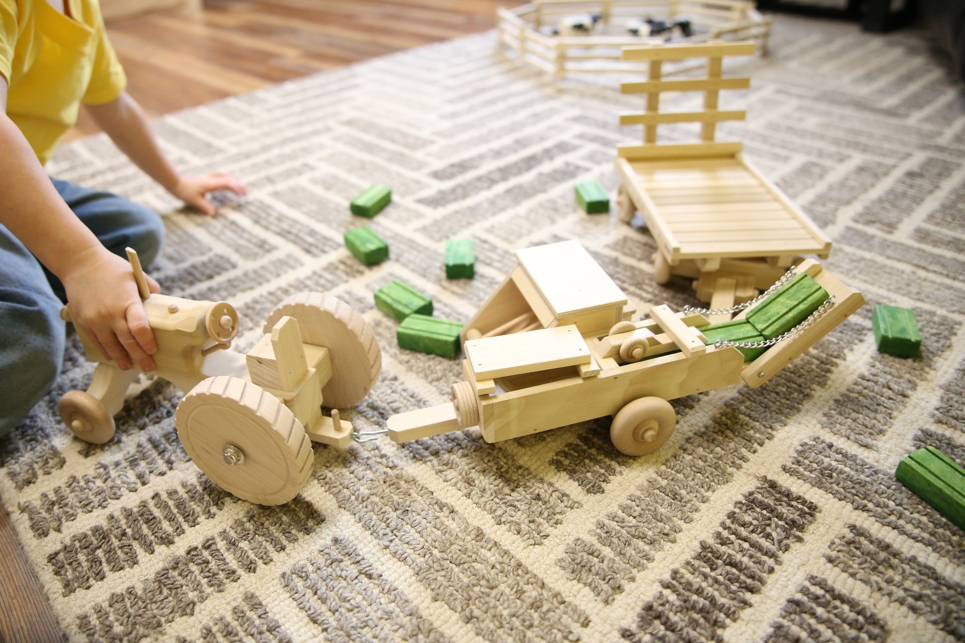 Wooden toy tractor, hay baler, hay wagon, and 16 hay bales from AmishToyBox Little Farmer Hay Baling Toy Set.