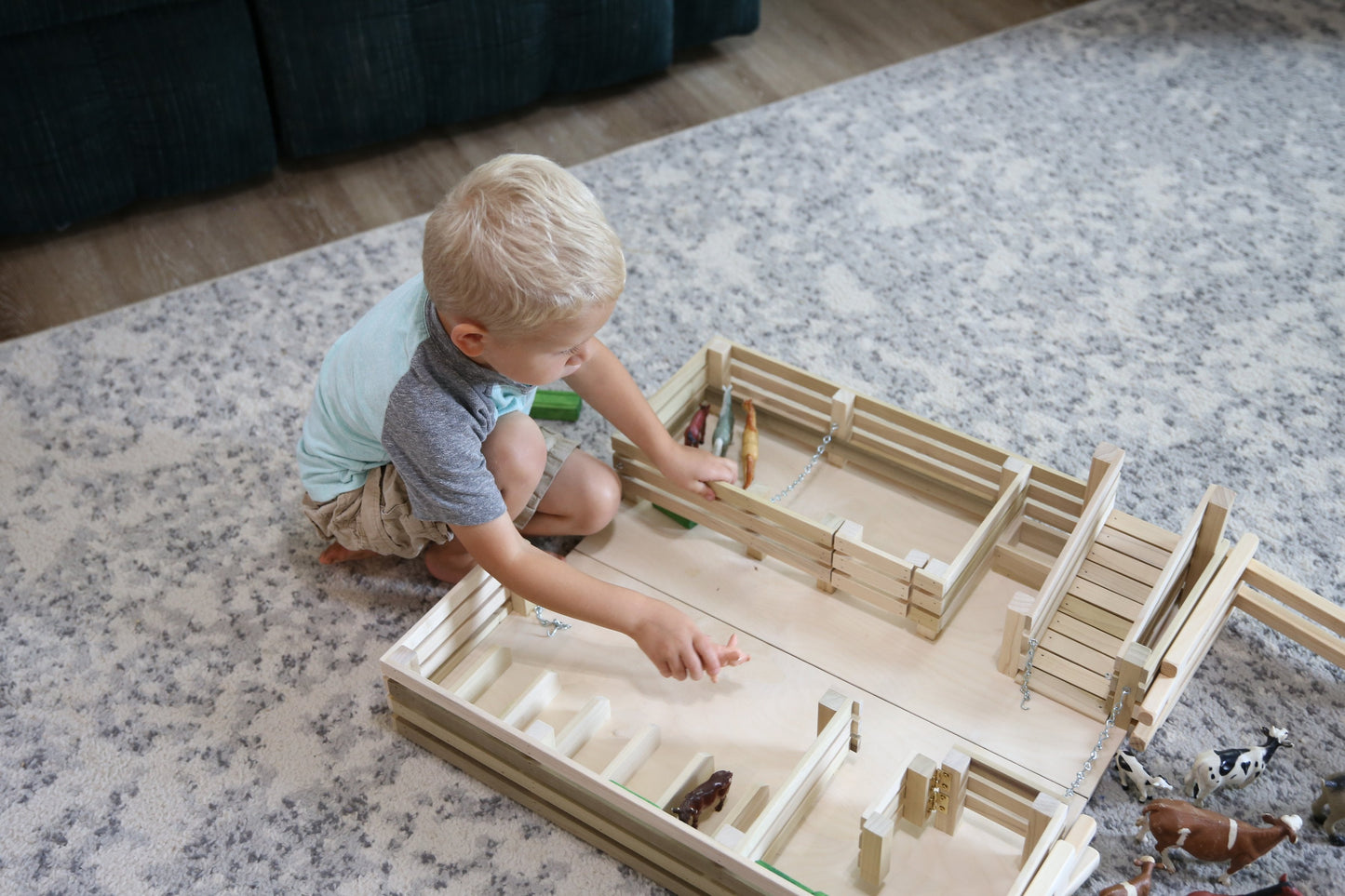 Amish-made wooden folding stock yard farm toy by AmishToyBox.com, unfinished, showing detailed wooden construction and farm toy features.