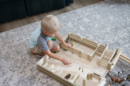 Amish-made wooden folding stock yard farm toy by AmishToyBox.com, unfinished, showing detailed wooden construction and farm toy features.