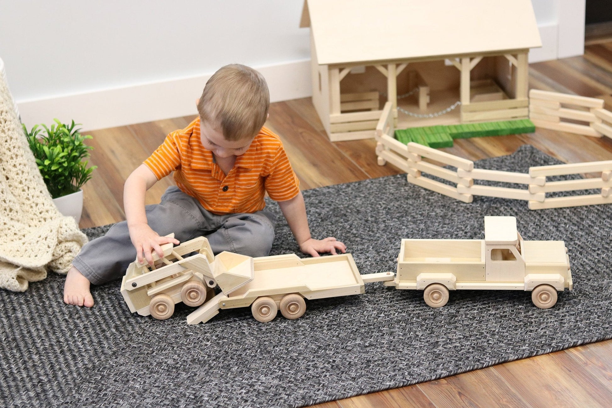Wooden toy pickup truck and flatbed trailer with skidloader set, made by AmishToyBox.com, featuring detailed wooden construction.