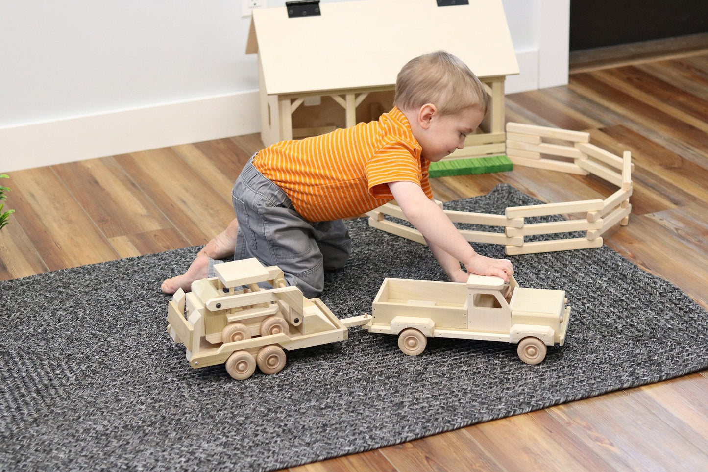 Wooden toy pickup truck and flatbed trailer with skidloader set, crafted from wood, featuring detailed, colorful construction for children.