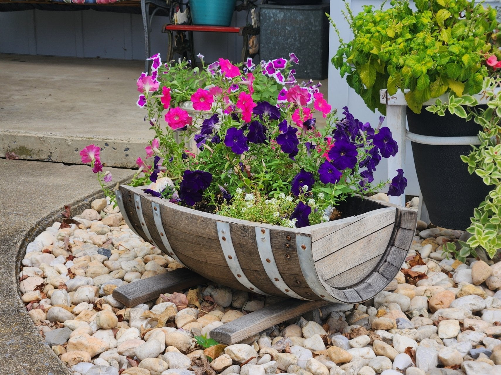 Rustic flower planter made from real white oak whiskey barrels, AmishToyBox.com, suitable for indoor or outdoor use.