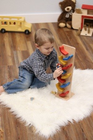 Amish-made mini wooden car roller toy with colorful car pack, handcrafted by AmishToyBox.com for imaginative play.