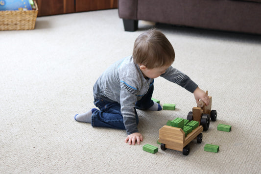 Amish-made wooden toy tractor and wagon set with hay bales, featuring detailed craftsmanship and natural wood finish.