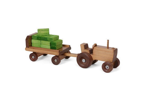 Amish-made wooden toy tractor and wagon set with hay bales, featuring detailed craftsmanship and natural wood finish.