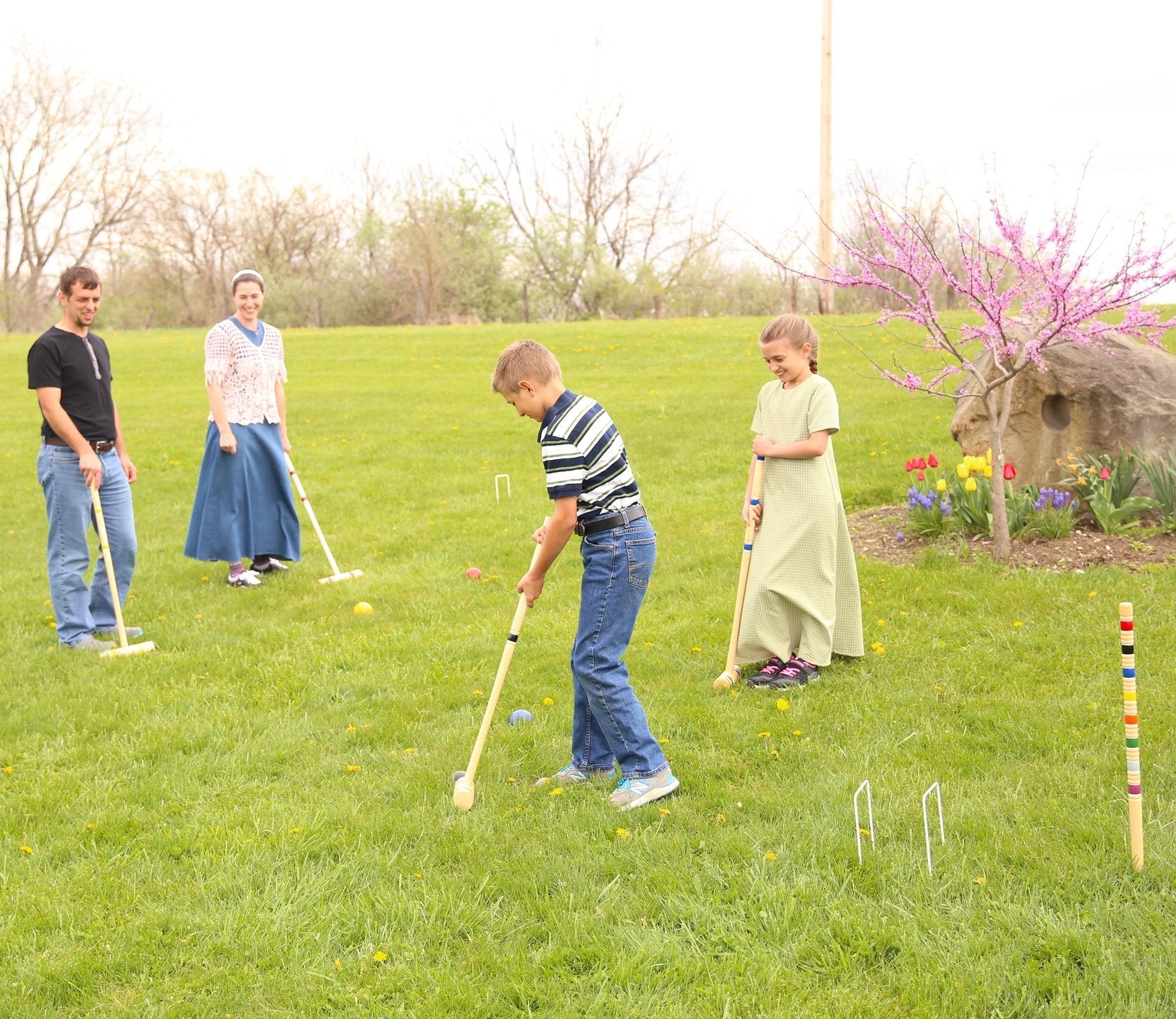 Amish-made Deluxe Croquet Game Set with six wooden balls, mallets, wickets, and wooden holder for outdoor family fun.