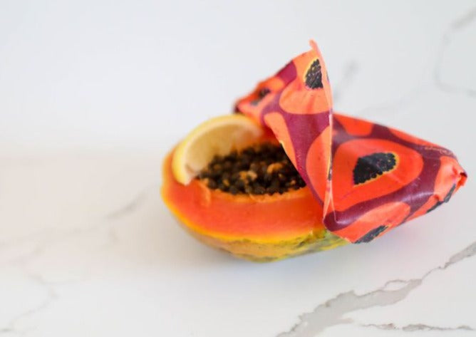 Meli Wraps beeswax roll in purple papaya print, bulk pack of reusable beeswax wraps for food storage.