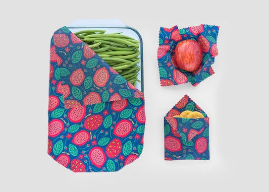 Set of three Meli Wraps beeswax food wraps with vibrant dragonfruit print in small, medium, and large sizes.