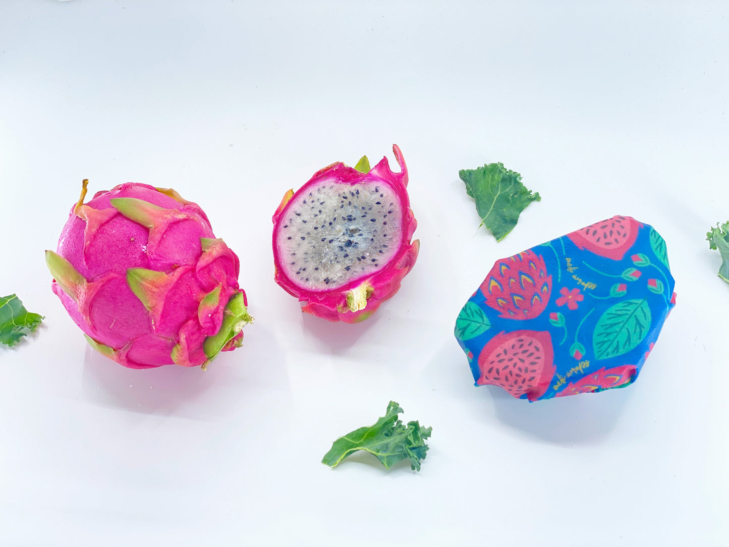 Set of three Meli Wraps beeswax food wraps with vibrant dragonfruit print in small, medium, and large sizes.
