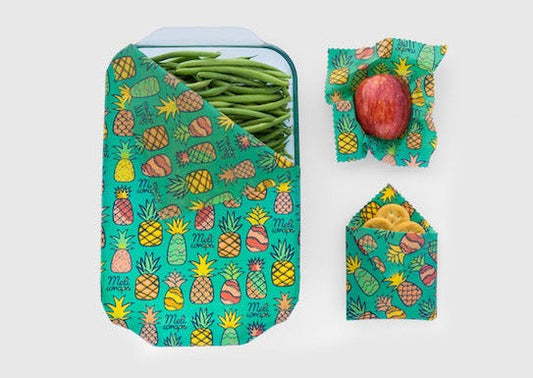 Set of three Meli Wraps beeswax food wraps with pineapple print in small, medium, and large sizes, featuring colorful tropical fruit designs.