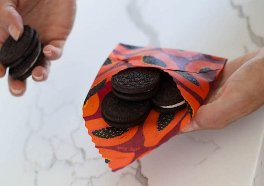 Set of Meli Wraps beeswax food wraps in purple papaya print, three sizes for eco-friendly food storage and wrapping.