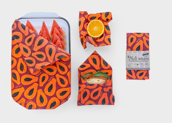 Set of Meli Wraps beeswax food wraps in purple papaya print, including small, medium, and large sizes for food storage.