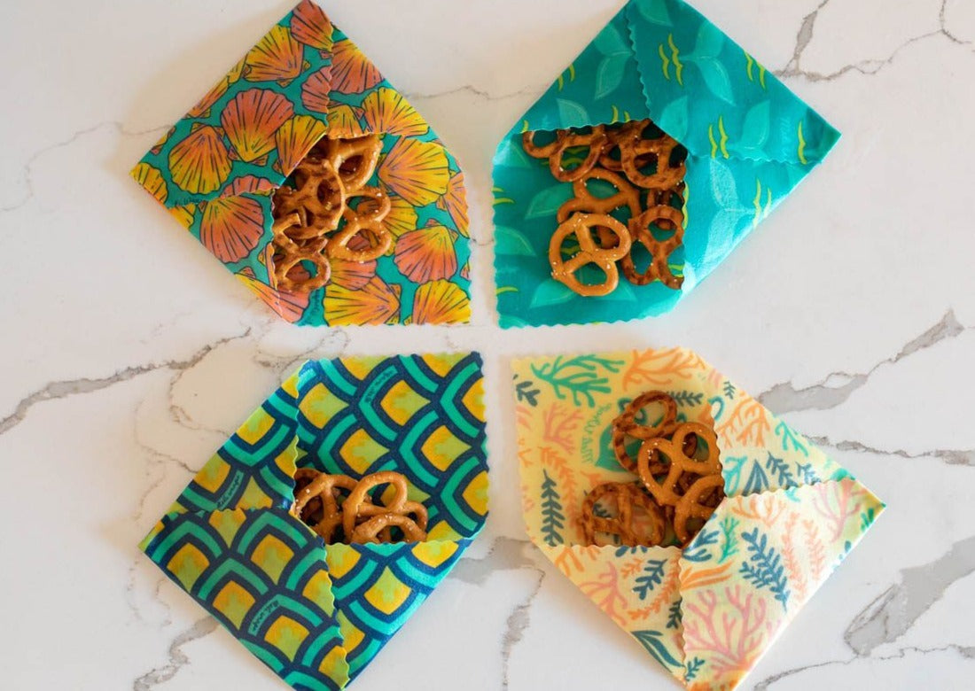 Set of Meli Wraps beeswax food wraps with sunrise shell print in small, medium, and large sizes for food storage.