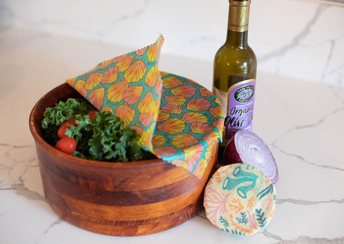 Set of Meli Wraps beeswax food wraps with sunrise shell print in small, medium, and large sizes for food storage.
