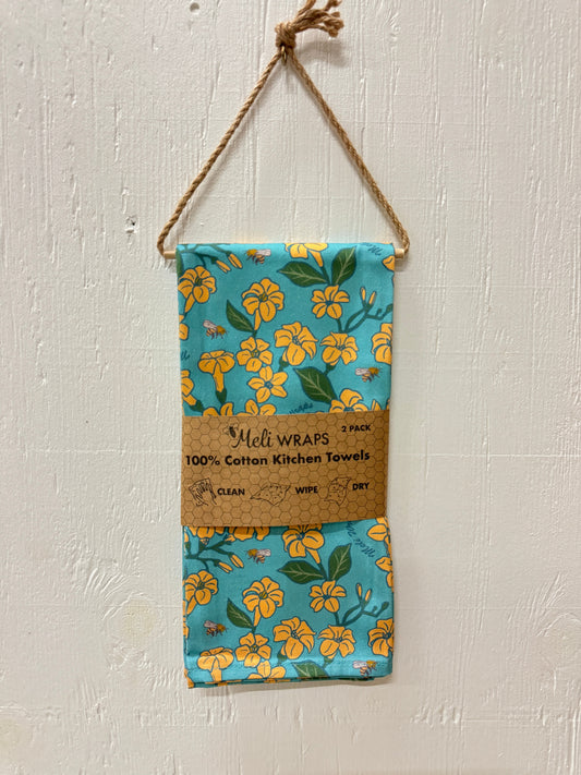 Set of two Puakenikeni and bee-themed kitchen towels by Meli Wraps, made from 100% cotton with colorful floral and bee designs.