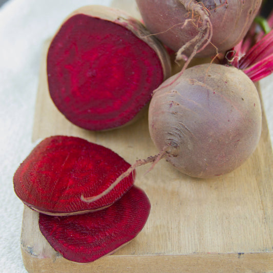 Early Wonder Tall Top Beet from MIgardener, showcasing vibrant green leaves and a round, deep red root vegetable.