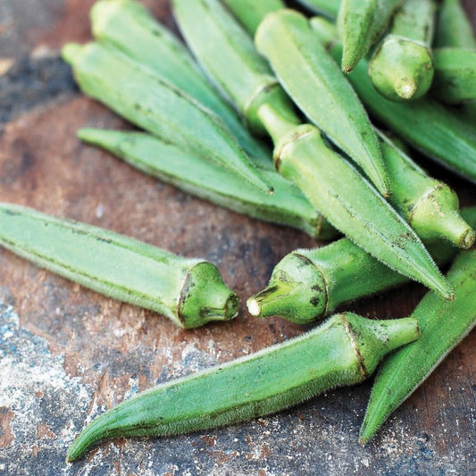 Long Pod Perkins okra from MIgardener, vibrant green okra pods with smooth skin and tapered shape on a white background.