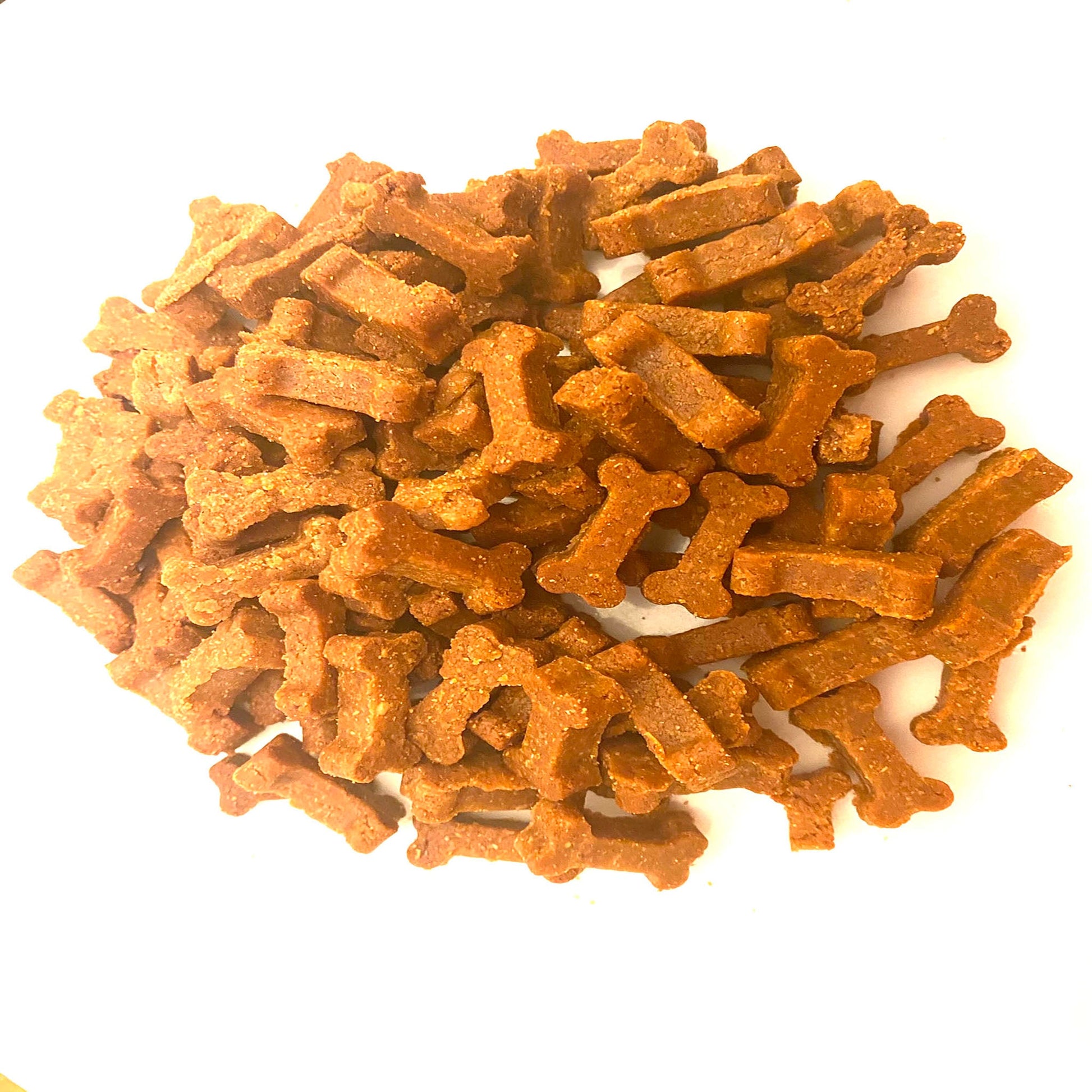 Organic peanut butter dog training treats in mini bone shapes from PAWsitively Organic Dog Bakery, ideal for rewarding dogs.
