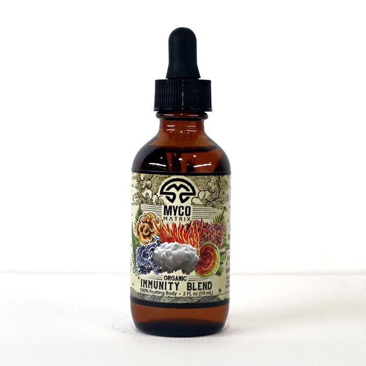 Mycomatrix Immunity Blend adaptogenic mushroom extract by Mushroom Mountain in a 2oz bottle with fresh mushroom visuals.