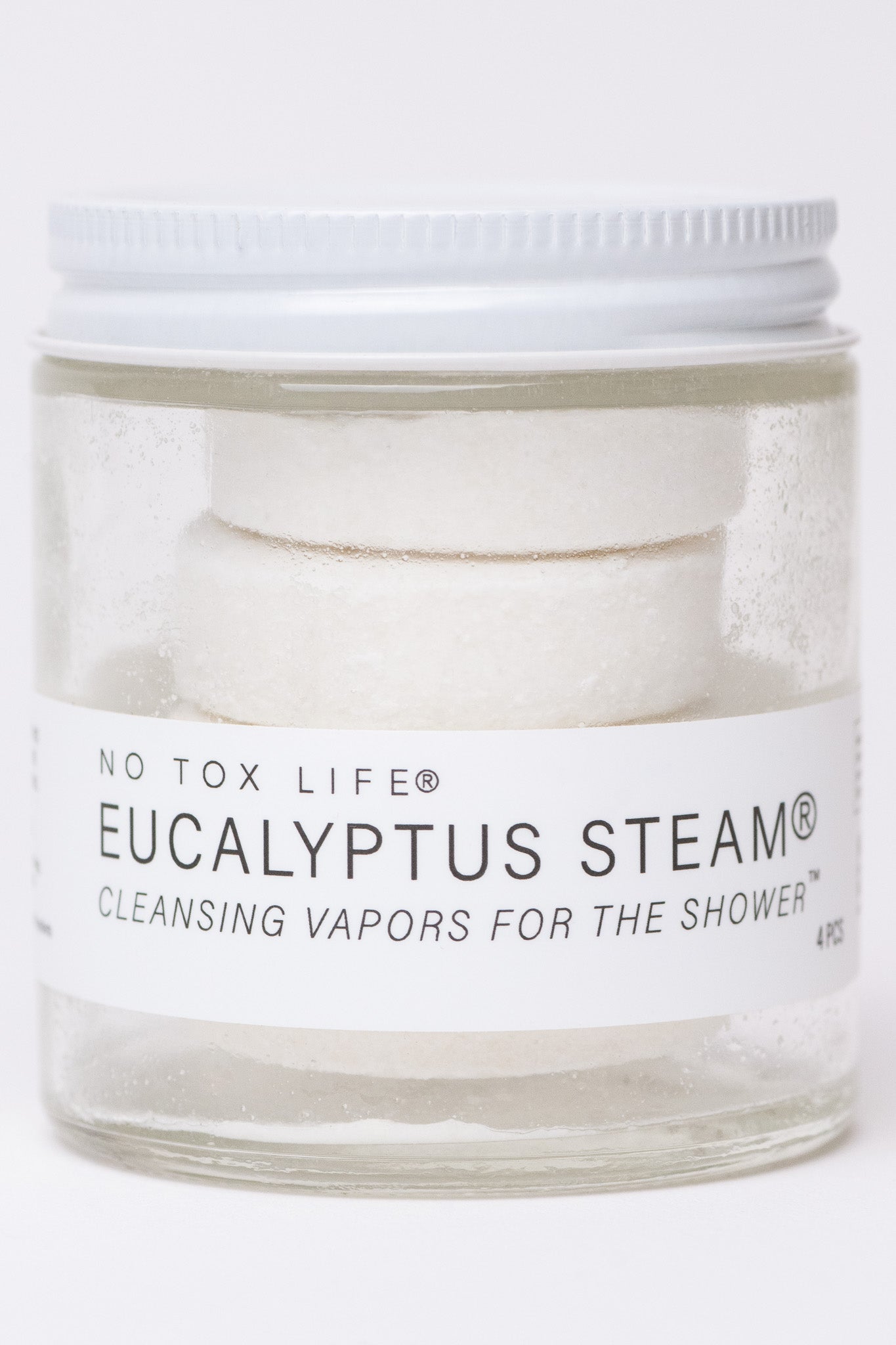 Mini jar of NO TOX LIFE Eucalyptus Steam® cleansing vapors for shower, featuring aromatic eucalyptus herbs in a small glass container.