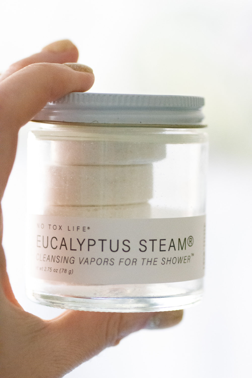 Mini jar of NO TOX LIFE Eucalyptus Steam® cleansing vapors for shower, featuring natural eucalyptus aroma in a small glass container.