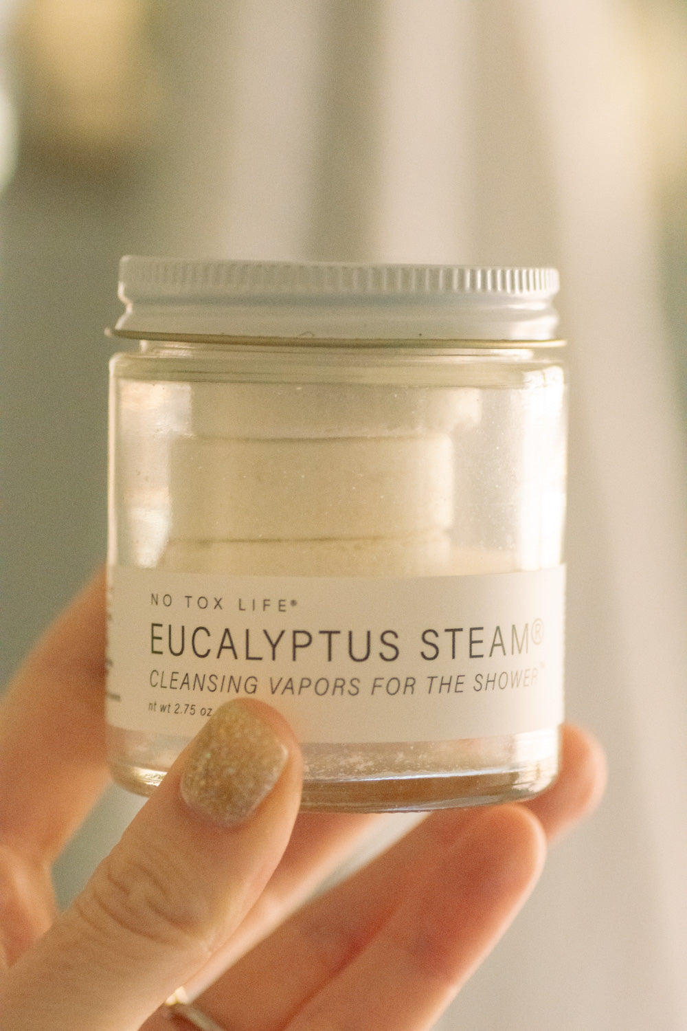 Mini jar of NO TOX LIFE Eucalyptus Steam Cleansing Vapors for the shower, with natural eucalyptus leaves and product label visible.