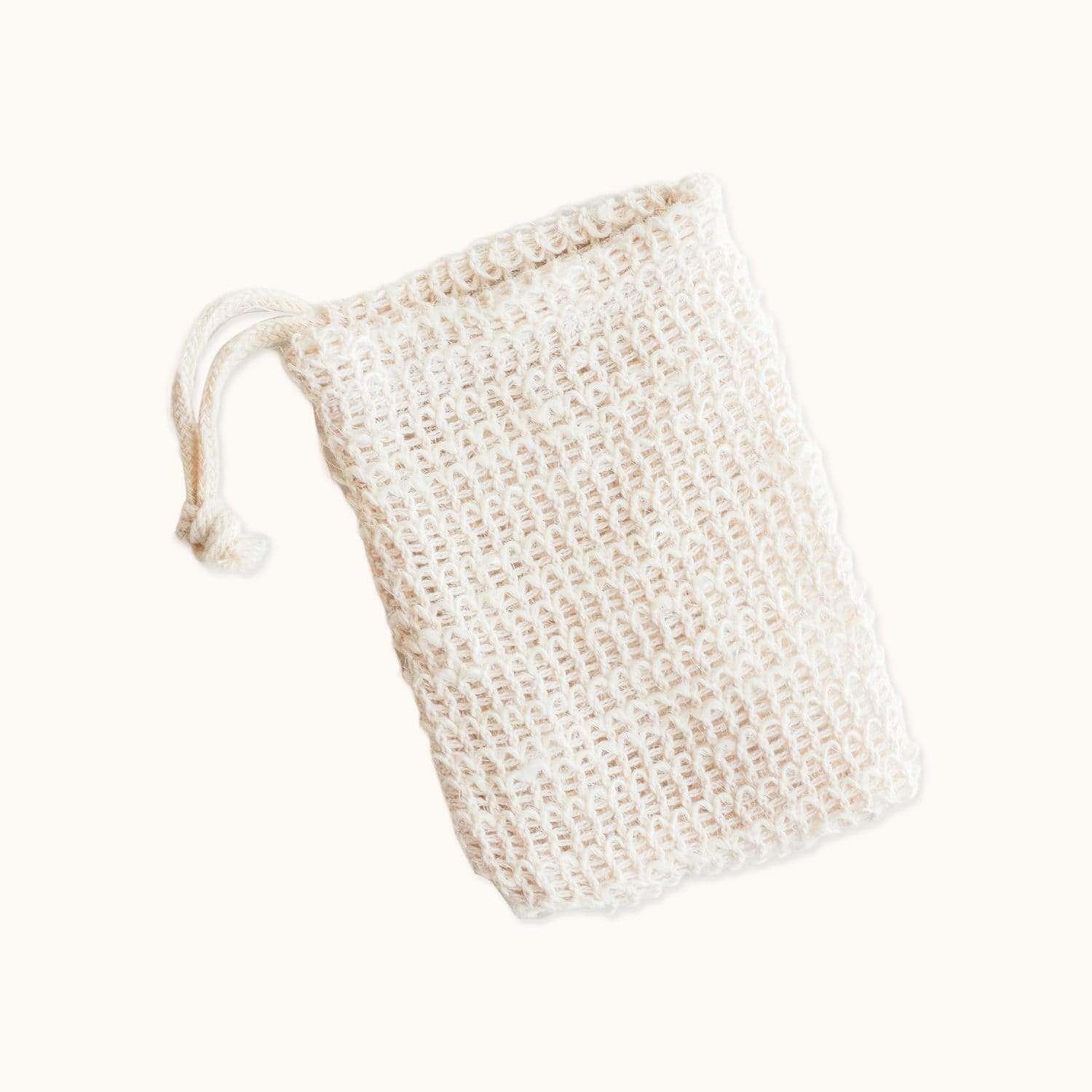 The Soap Saver Bag from ZeroWasteStore.com is a cream-colored, woven mesh pouch made of natural agave fiber with a drawstring—ideal as an exfoliating soap bag for a zero waste routine. Displayed on a plain light background.
