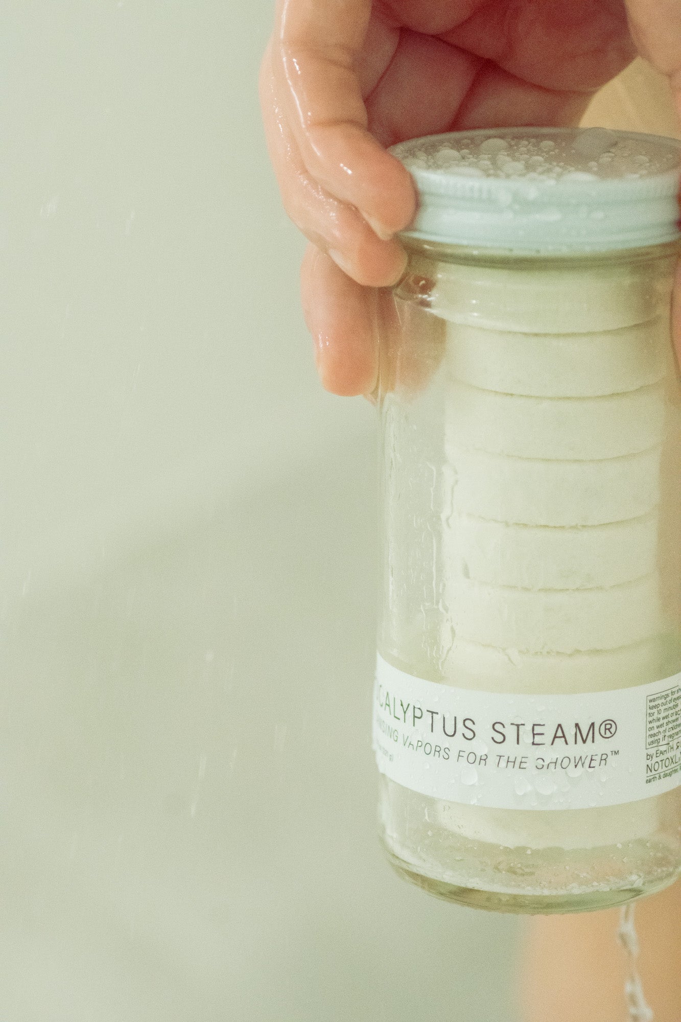 Eucalyptus Steam cleansing vapors for shower in a normal jar by NO TOX LIFE, with fresh eucalyptus leaves and steaming vapor.