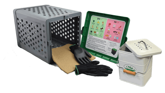 The Ollegardens OLLE Garden In-ground Worm Compost Bin, black gardening gloves, a brown mat, a small white Ollie compost bin, and a composting guide help support sustainable gardening for your garden beds.