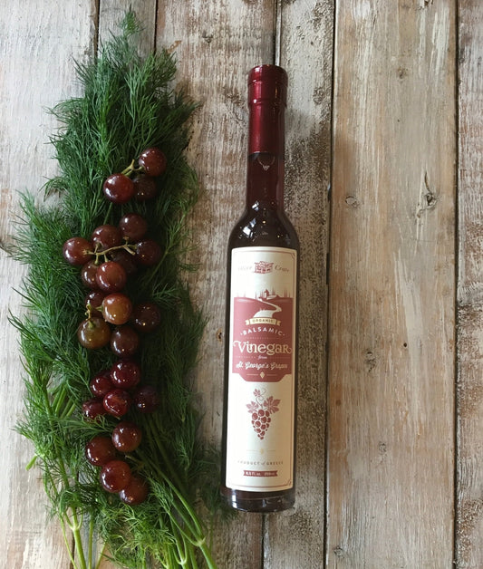 Organic balsamic vinegar from St. George's grapes by Olive Crate, shown in a glass bottle with a dark, rich liquid.