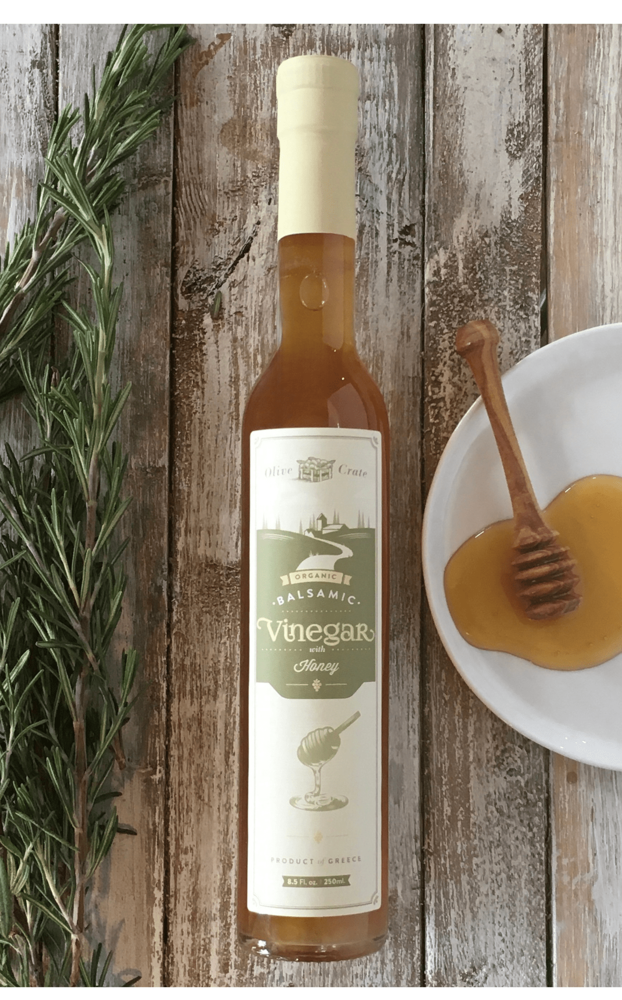Organic White Balsamic Vinegar with Honey by Olive Crate, featuring a clear glass bottle and Greek Roditis grapes.