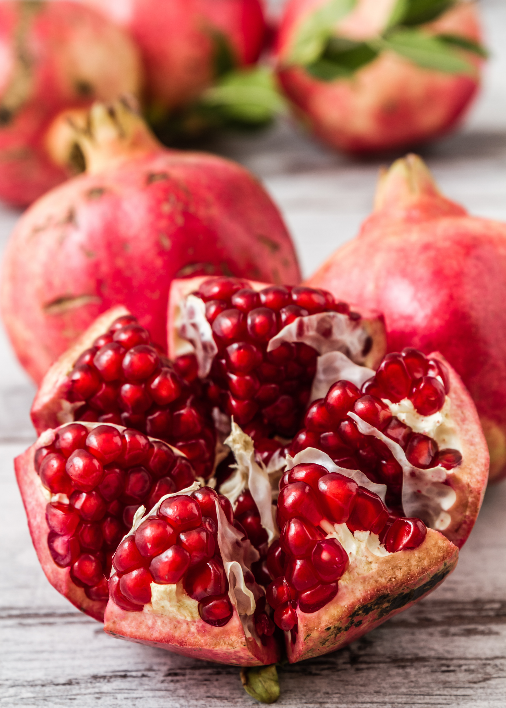 Pomegranate 'Parfianka' tropical fruit tree by Sow Exotic, showing healthy young pomegranate tree with green leaves and new growth.