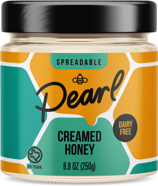 Creamed honey from Pearl Honey Spreads in a jar with a smooth, whipped texture, ready to spread on toast or pastries.