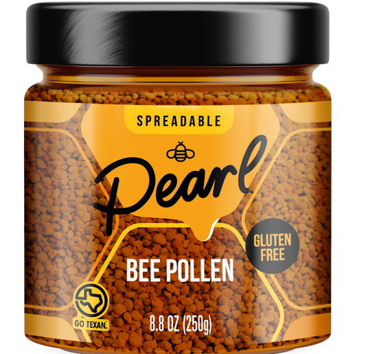 Jar of Pearl Honey Spreads honey with bee pollen, showing golden honey with bee pollen granules on the lid and label.