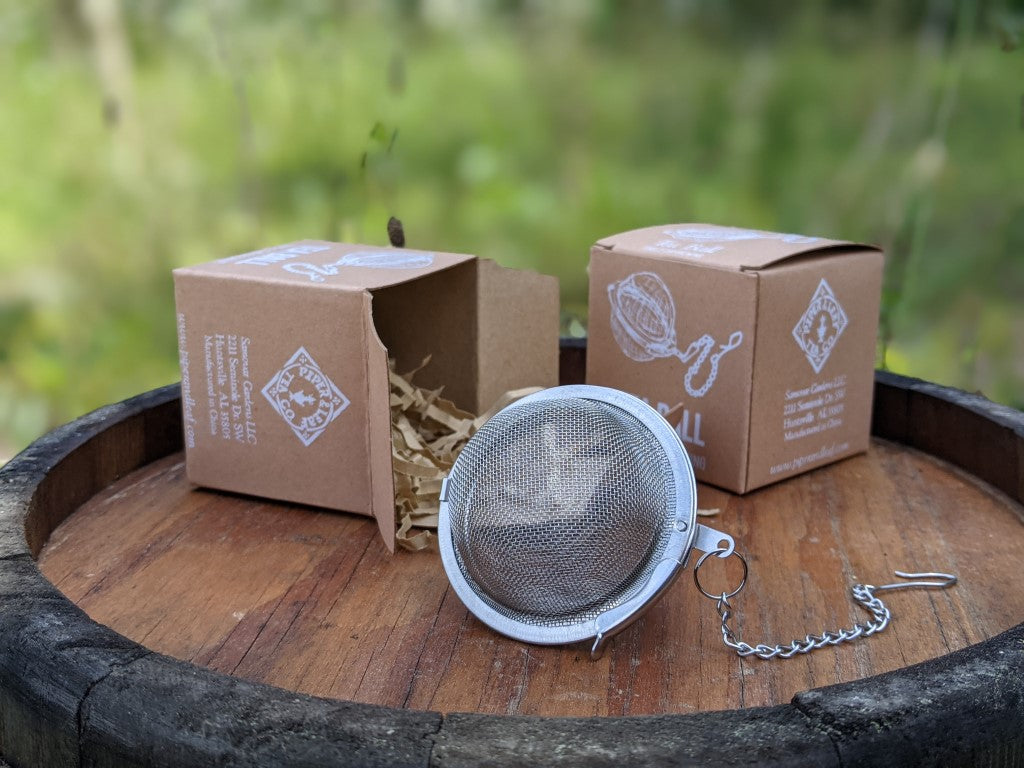 Piper Tea Ball brewing device from Piper and Leaf Tea Co., stainless steel infuser for loose leaf tea, round design with handle