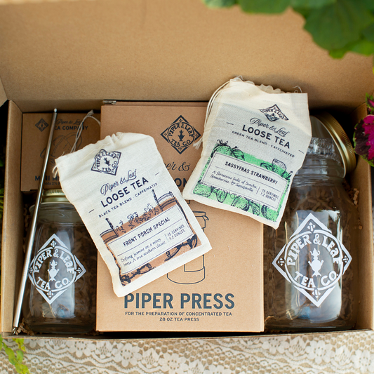 Piper Press Brew Kit from Piper and Leaf Tea Co. featuring a classic design with a brewing press and strawberry-themed accessories.