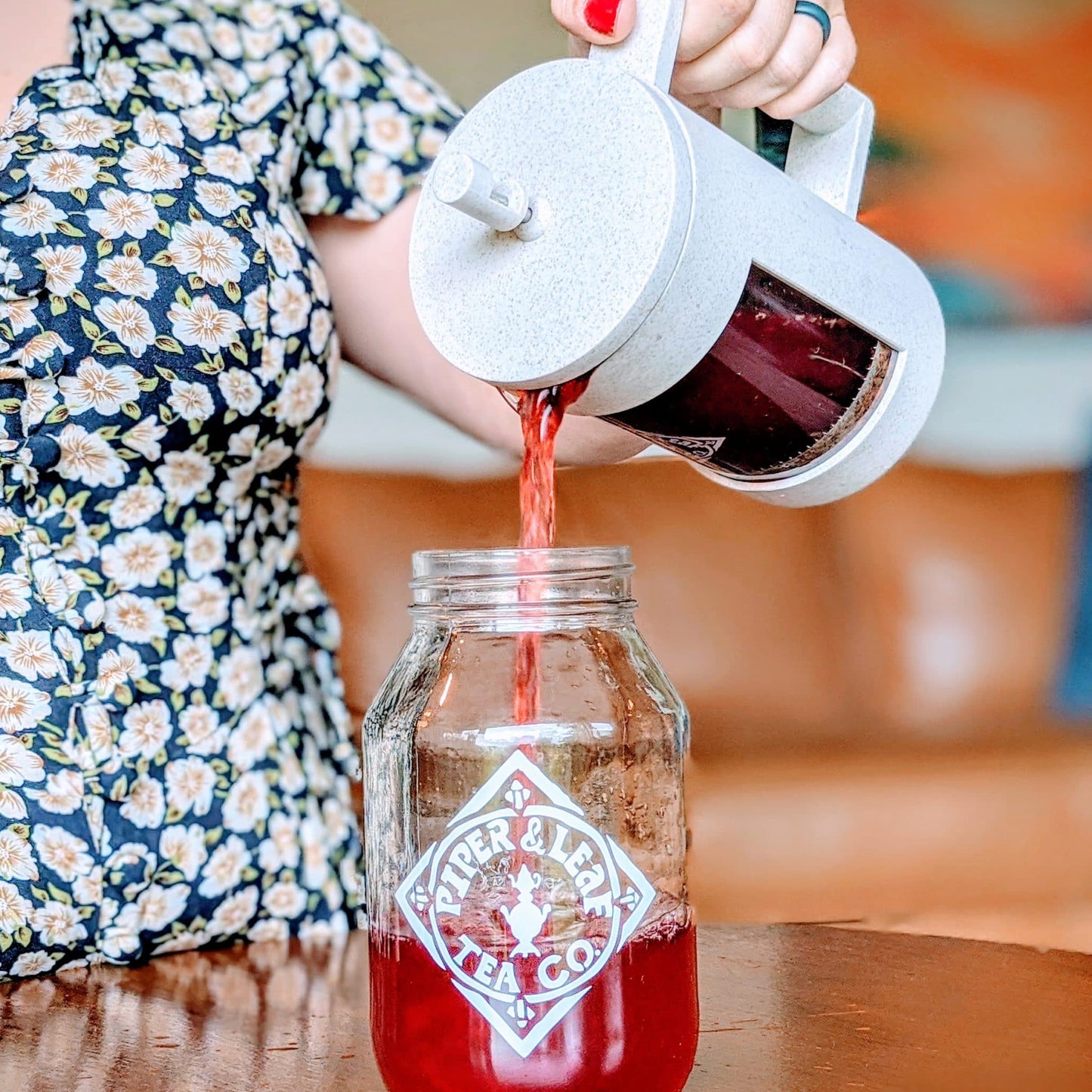 Piper Press Brew Kit from Piper and Leaf Tea Co., featuring a classic porch scene with tea accessories and strawberry-themed packaging.