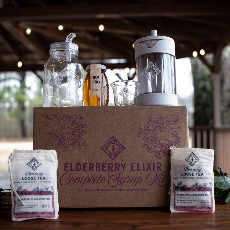 Elderberry Elixir Complete Syrup Kit gift set by Piper and Leaf Tea Co. includes bottles, measuring tools, and ingredients for making syrup.