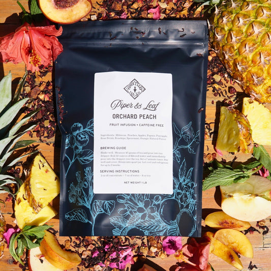 Piper and Leaf Tea Co. Orchard Peach loose tea in a pound bag, showcasing dried peach-flavored tea leaves for 190 servings.